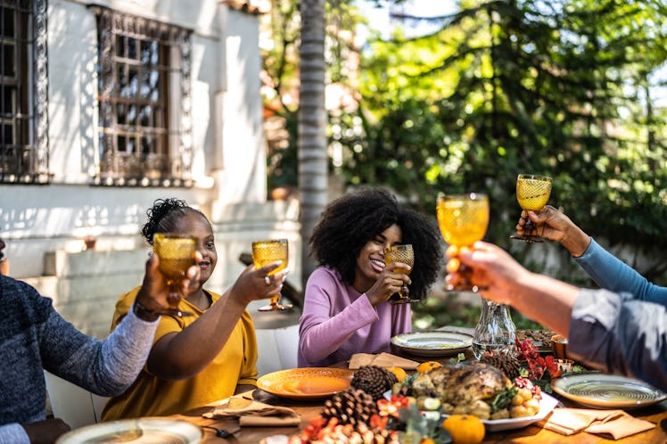 Family toasting at Thanksgiving, which they'll share in their chat with some Thanksgiving-themed gro...