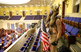 WASHINGTON, DC - JANUARY 06: A protester yells inside the Senate Chamber on January 06, 2021 in Wash...