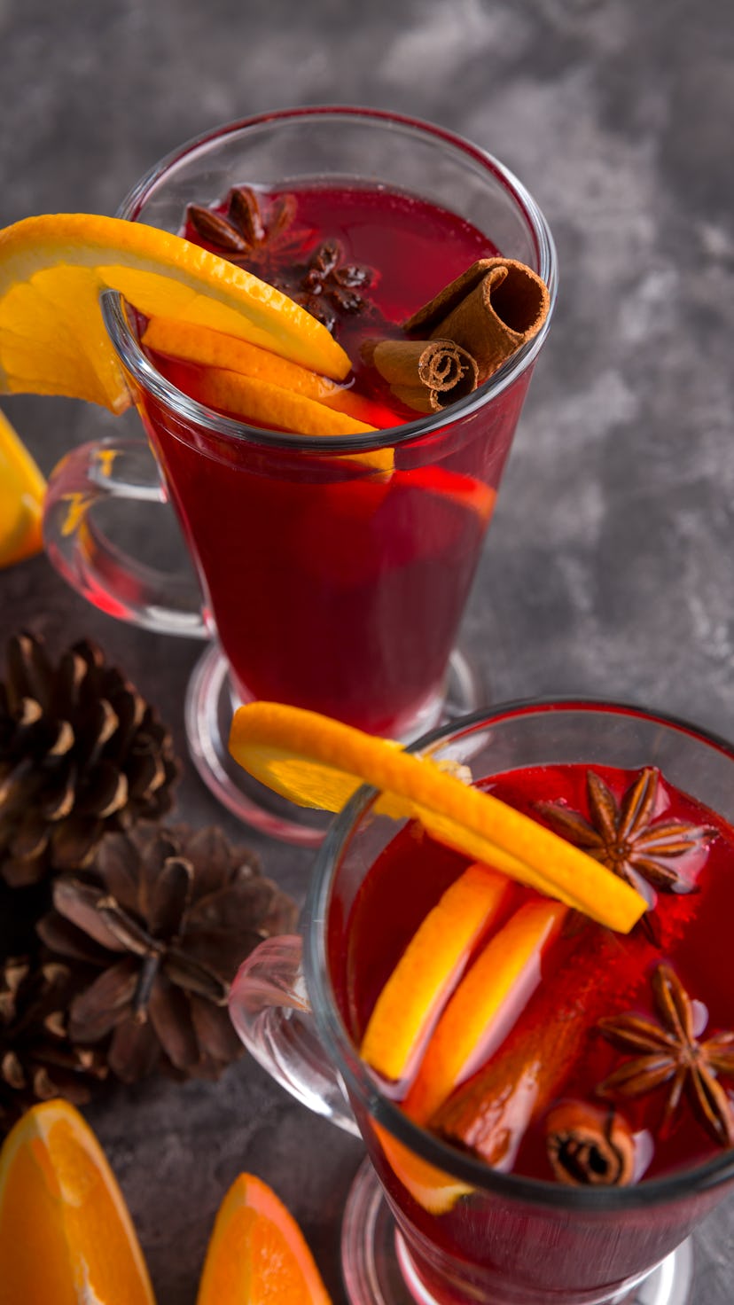 Two mugs of mulled wine. Ingredients for a cocktail. Hot winter drinks based on champagne. Copy spac...