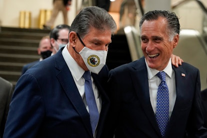 WASHINGTON, DC - NOVEMBER 4: Senator Joe Manchin (D-WV) walks with Senator Mitt Romney (R-UT) after ...