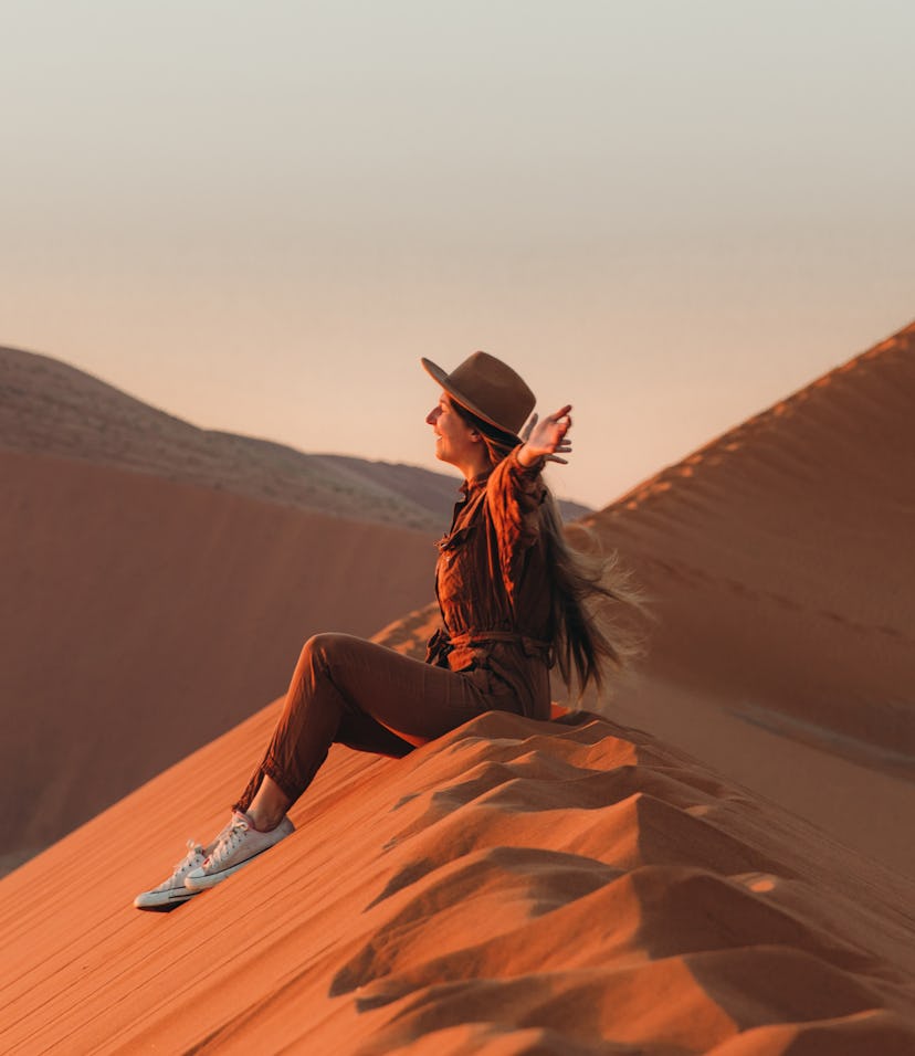 young woman with arms out wide as she reflects on north node in sagittarius