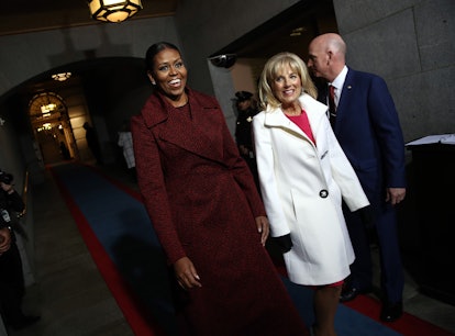 First lady Michelle Obama (L) and Jill Biden arrive on the West Front of the US Capitol on January 2...