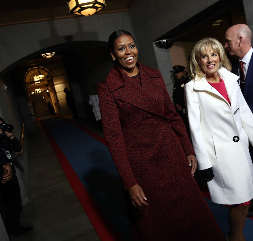 First lady Michelle Obama (L) and Jill Biden arrive on the West Front of the US Capitol on January 2...