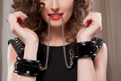 This woman wearing handcuffs is new to being submissive in bed. 