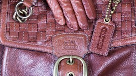 Fair Oaks, California, USA - November 21, 2011: Coach handcrafted brown leather bag with matching le...