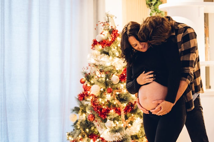 Couple in their living room surrounded with love and Christmas