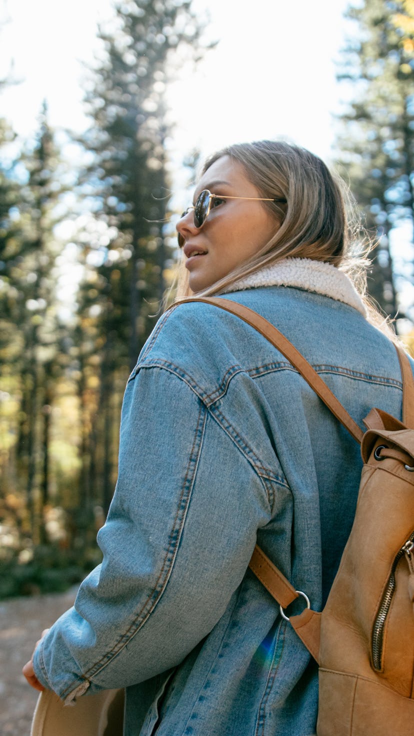 A woman hikes. Sagittarius season kicks off on November 21, 2021.