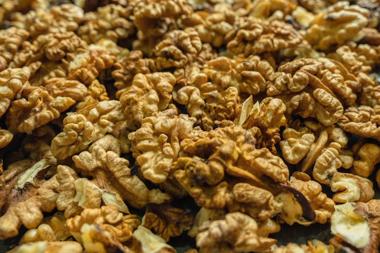 Background of peeled walnuts. Close-up. Selective focus