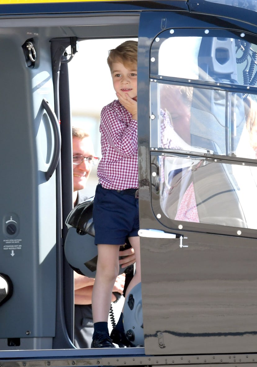 Prince George is filled with delight viewing a helicopter.