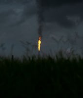 NORCO, LA - AUGUST 21: A gas flare from the Shell Chemical LP petroleum refinery illuminates the sky...