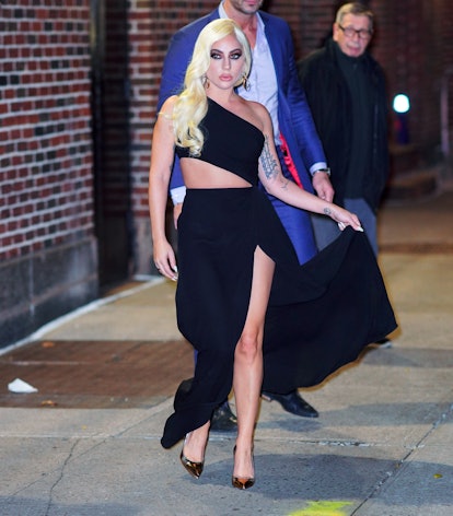 Lady Gaga wears one-shoulder black Valentino Spring/Summer 2022 gown.