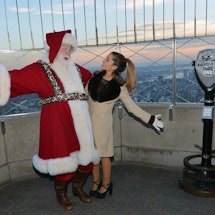 NEW YORK, NY - NOVEMBER 25:  Actress/singer Ariana Grande and Santa Claus visit The Empire State Bui...