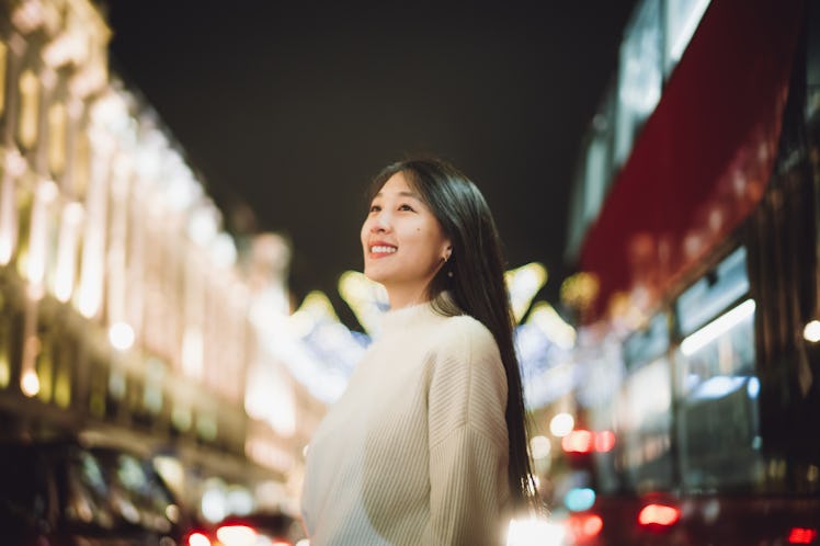 Beautiful Asian woman looking at the Christmas light decoration at Regent street, London