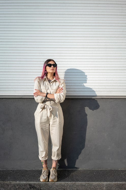 A woman in a white jumpsuit folds her arms in front of an industrial wall. These are the most defens...