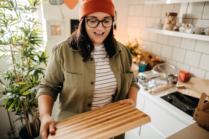 Photo of a young woman making homemade pasta in the kitchen. Here's your daily horoscope for Novembe...