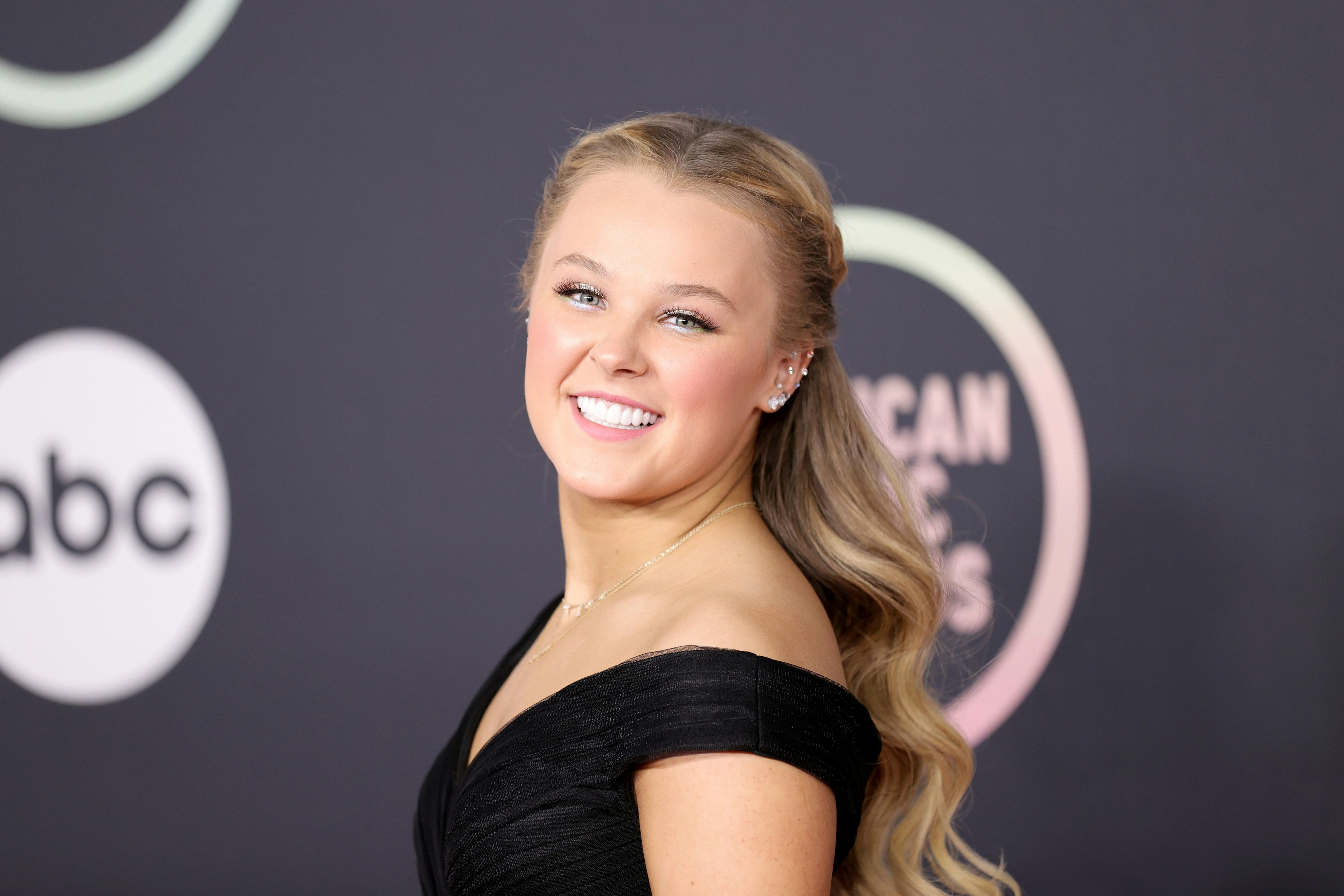 Instead of rocking her signature ponytail, JoJo Siwa wore her hair down at the 2021 American Music A...
