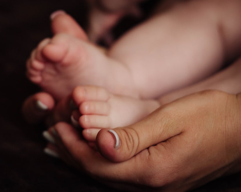 baby feet in an adults hands