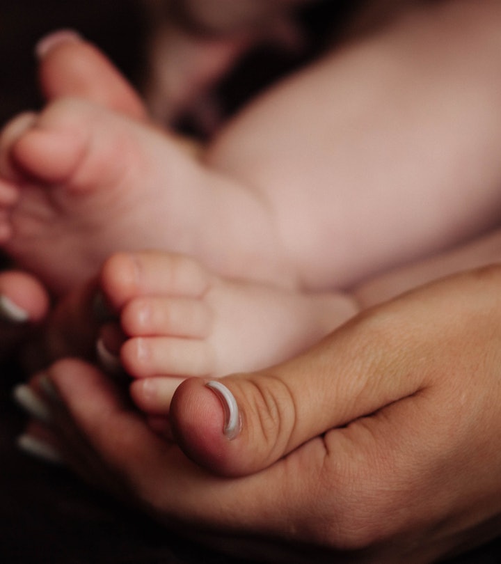 baby feet in an adults hands