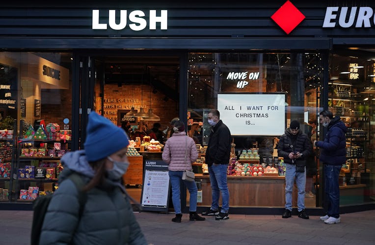 BERLIN GERMANY - NOVEMBER 28: Shoppers wait to enter a Lush cosmetics store with a Christmas theme o...