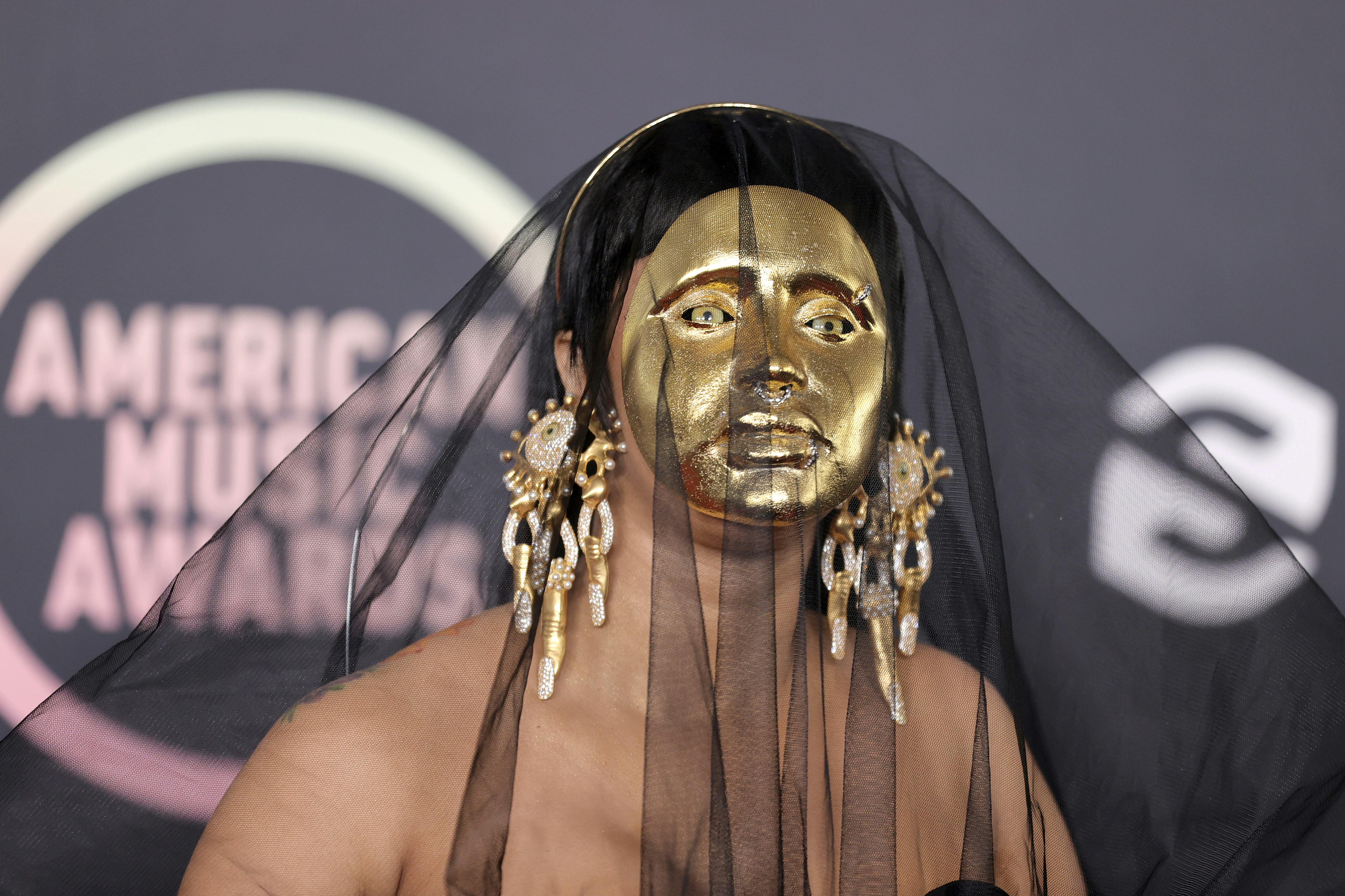 Cardi B's 2021 AMAs red carpet look included a gold mask.