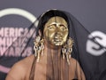 Cardi B's 2021 AMAs red carpet look included a gold mask.