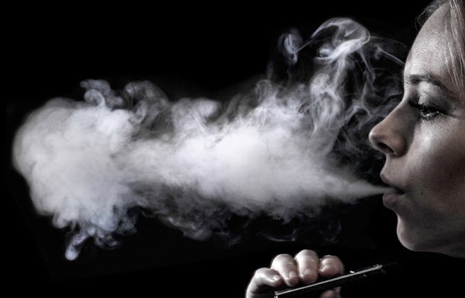 young women vaping