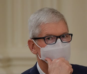 WASHINGTON, DC - AUGUST 25: Apple CEO Tim Cook listens as U.S. President Joe Biden speaks during a m...