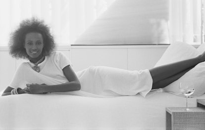 Portrait of Somali-born American actress and model Iman (born Iman Abdulmajid) as she lies on a bed,...