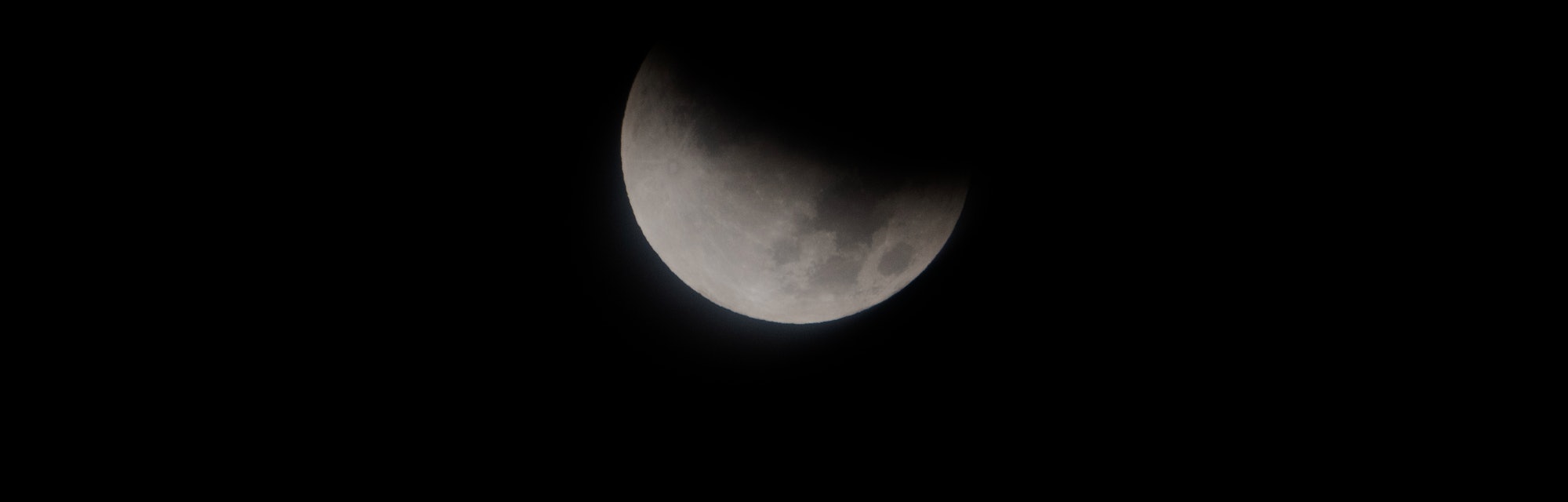 UNITED STATES - NOVEMBER 19: The moon is seen from Washington, D.C., during a partial lunar eclipse ...