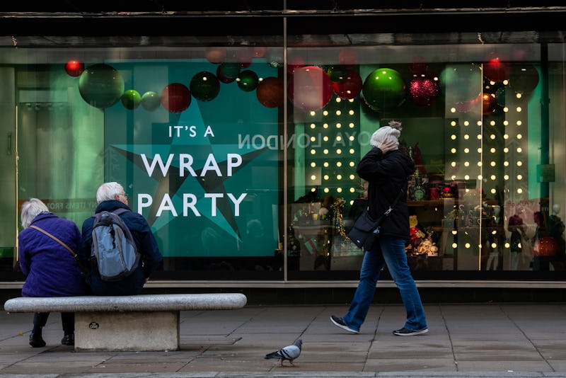 LONDON, ENGLAND - NOVEMBER 07: A shopper walks past a Christmas window display at John Lewis, Oxford...