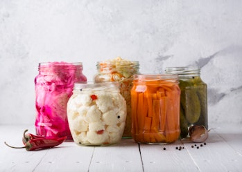 Fermented vegetables. Homemade marinated cabbage with carrot and cucumbers, sauerkraut sour in glass...