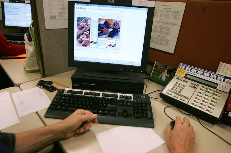 Manfred Bracklow, an ecommerce representative, sitting at his desk as he looks at the on-line catalo...