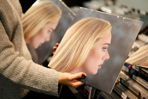 A member of staff sorts copies of the new album from British singer-songwriter Adele, "30" in Sister...