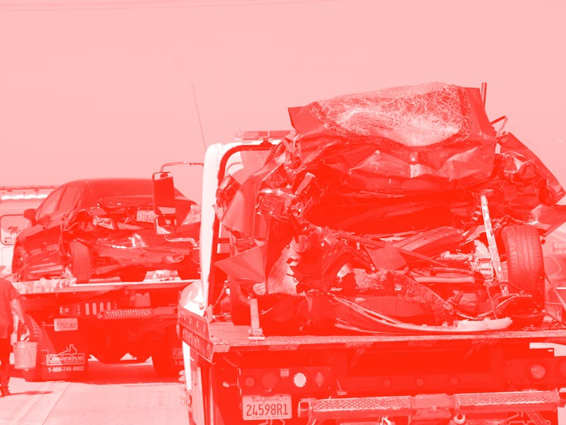 SEAL BEACH, CA - AUGUST 15: A damaged Tesla, right, and Honda Civic, sit on tow trucks after a colli...