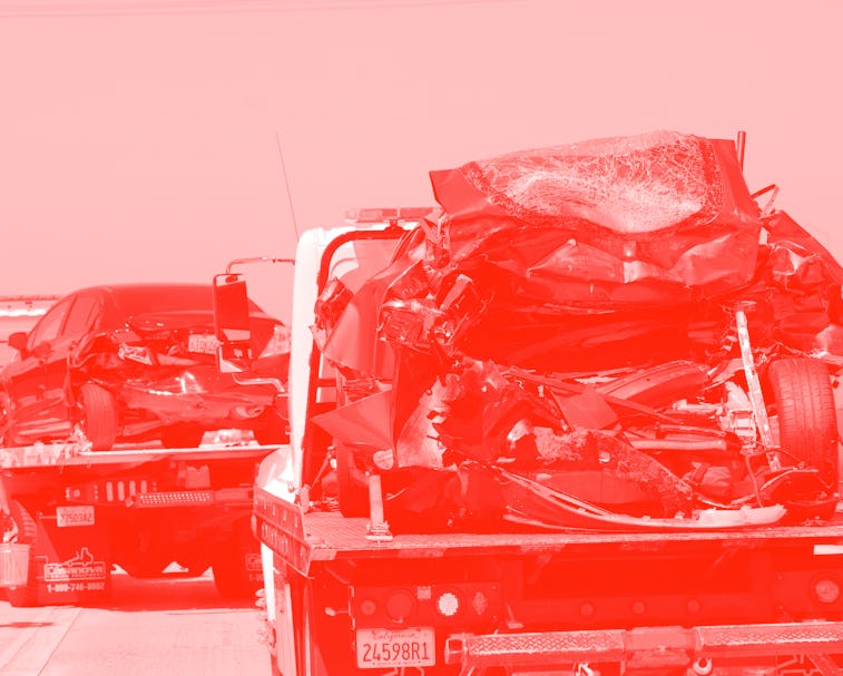 SEAL BEACH, CA - AUGUST 15: A damaged Tesla, right, and Honda Civic, sit on tow trucks after a colli...