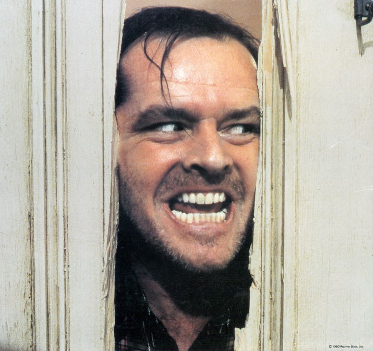 Jack Nicholson peering through axed in door in lobby card for the film 'The Shining', 1980. (Photo b...