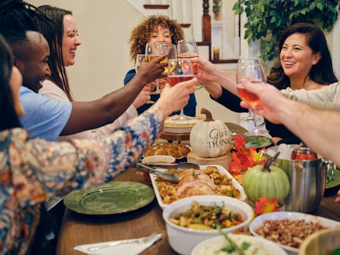 A group of friends celebrating Thanksgiving together. Here's your daily horoscope for Thanksgiving w...