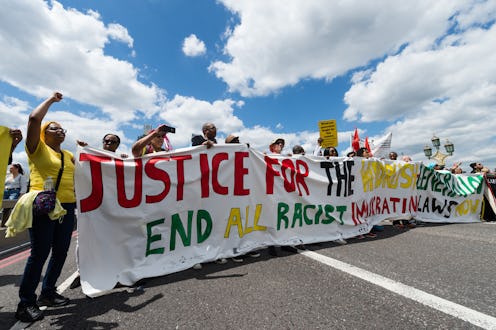 A group of protesters gather on Westminster Bridge to mark the first official Windrush Day with a de...
