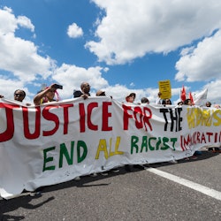 A group of protesters gather on Westminster Bridge to mark the first official Windrush Day with a de...