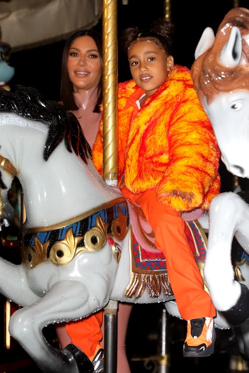 PARIS, FRANCE - MARCH 01: Kim Kardashian and North West are seen on a carousel at the Eiffel Tower o...