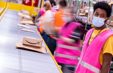 13 October 2021, Mecklenburg-Western Pomerania, Neubrandenburg: Employees sort parcels from online r...