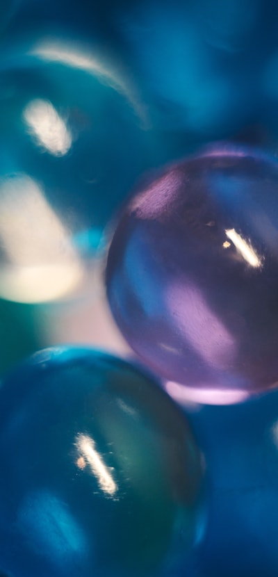 Hydrogel beads close-up, abstract background. Blue purple orbeez.