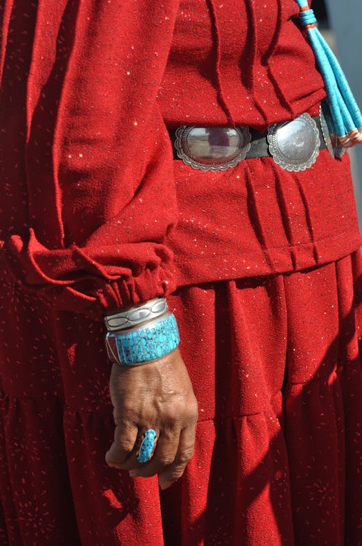 A Native-American woman from the Navajo Reservation wears traditional turquoise and silver jewelry