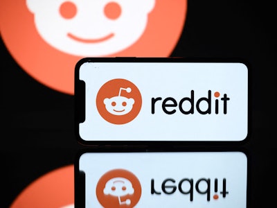 A picture taken on October 5, 2021 in Toulouse shows the logo of Reddit social media displayed by a ...