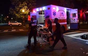 WASHINGTON, DC - JULY 16: D.C. Fire and EMS personnel with the help of D.C. police, transport a man ...