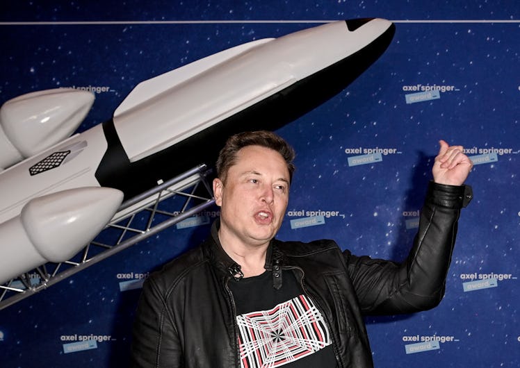 SpaceX owner and Tesla CEO Elon Musk (R) gestures as he arrives on the red carpet for the Axel Sprin...