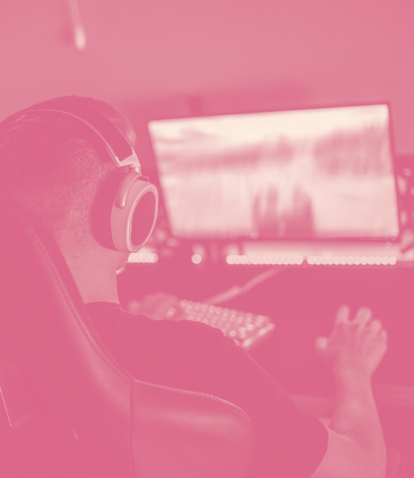 teenager boy playing video games in a dark room, wearing a white headset