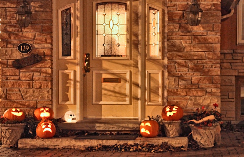 Jack-o'-lanterns rest on a doorstep during Halloween night in Toronto, Ontario, Canada.  (Photo by C...