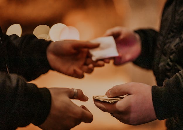 Addict young man have meeting with dealer at night to buy dose of white powder cocaine.