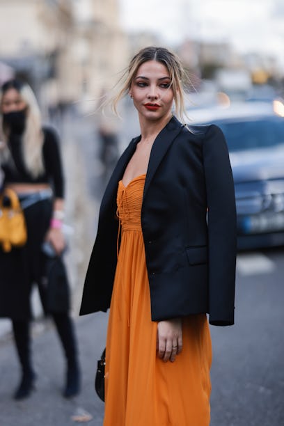 Madelyn Cline, who reignited dating rumors with Ross Butler, wears orange dress and black blazer out...